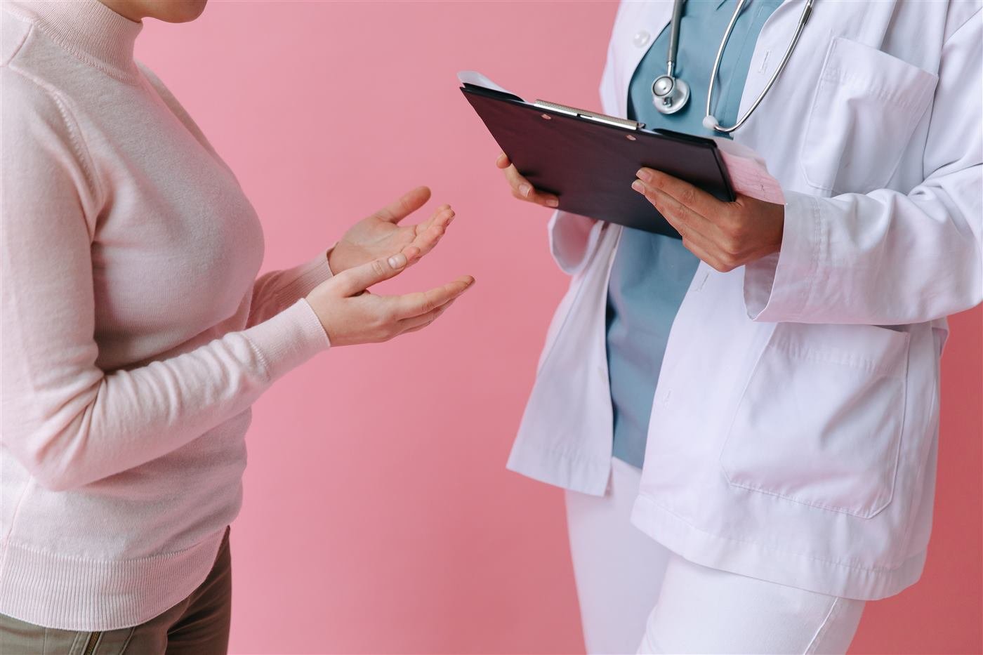 Doctor reviewing a patient's case notes during a consultation